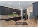Well-equipped kitchen with dark cabinetry, granite counters, and stainless steel appliances at 1638 Whitney Isles Dr, Windermere, FL 34786