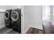 The laundry room features front loading washer and dryer on a complimentary wood floor at 1638 Whitney Isles Dr, Windermere, FL 34786