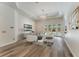 Bright living room with hardwood floors, modern furniture, and access to outdoor pool at 1638 Whitney Isles Dr, Windermere, FL 34786
