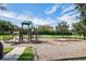 A playground with slides, swings, and climbing structures is set in a landscaped area at 1638 Whitney Isles Dr, Windermere, FL 34786