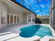 Private backyard featuring a screened-in pool, patio area, and well-manicured landscaping at 1638 Whitney Isles Dr, Windermere, FL 34786