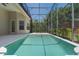 The backyard features a screened in pool and a private setting with green foliage at 1638 Whitney Isles Dr, Windermere, FL 34786