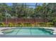 Backyard pool with screened enclosure and brick wall creating a private outdoor space at 1638 Whitney Isles Dr, Windermere, FL 34786