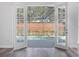 View of the pool and backyard through open French doors, bringing the outdoors in at 1638 Whitney Isles Dr, Windermere, FL 34786
