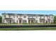Charming new construction townhome with white siding, black roof, and manicured lawn at 1664 Crowncrest Dr, Apopka, FL 32703