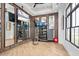 Well-equipped fitness center with mirrors, wood floors, and plenty of natural light at 1664 Crowncrest Dr, Apopka, FL 32703