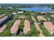 An aerial view of the community shows mature trees, a lake and well-maintained buildings at 1810 Shadow View Cir # 1810, Maitland, FL 32751
