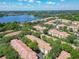 An aerial view of the community shows mature trees, a lake and well-maintained buildings at 1810 Shadow View Cir # 1810, Maitland, FL 32751