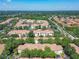 An aerial view showcases the community, featuring well-maintained buildings, lush landscaping, and mature trees at 1810 Shadow View Cir # 1810, Maitland, FL 32751