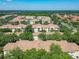 An aerial view showcases the community, featuring well-maintained buildings, lush landscaping, and mature trees at 1810 Shadow View Cir # 1810, Maitland, FL 32751