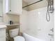 Bright bathroom featuring a white tiled shower and tub combination with storage at 1810 Shadow View Cir # 1810, Maitland, FL 32751