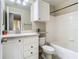 Well-lit bathroom featuring white cabinets, sink, toilet, and a combined bathtub and shower at 1810 Shadow View Cir # 1810, Maitland, FL 32751