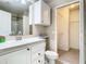 Bright bathroom featuring a white vanity, mirror, and a peek at the walk-in closet at 1810 Shadow View Cir # 1810, Maitland, FL 32751