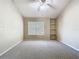 Bedroom featuring neutral walls, carpet, a ceiling fan, a window, and built-in shelves at 1810 Shadow View Cir # 1810, Maitland, FL 32751