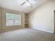 Spacious bedroom features a window, built-in shelves, carpet, and a ceiling fan at 1810 Shadow View Cir # 1810, Maitland, FL 32751