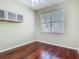 Cozy bedroom with hardwood floors, built in cabinetry, and natural light from the window at 1810 Shadow View Cir # 1810, Maitland, FL 32751