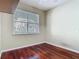 Bright bedroom features hardwood floors and a large window that provides ample natural light at 1810 Shadow View Cir # 1810, Maitland, FL 32751