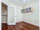 Bright bedroom featuring hardwood floors, built in cabinetry, and view of the kitchen at 1810 Shadow View Cir # 1810, Maitland, FL 32751