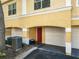 Two-story condo with a garage and a red front door at 1810 Shadow View Cir # 1810, Maitland, FL 32751