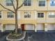 Two-story condo with a garage and a red front door at 1810 Shadow View Cir # 1810, Maitland, FL 32751