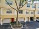 Two-story condo with a garage and a red front door at 1810 Shadow View Cir # 1810, Maitland, FL 32751
