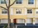Two-story condo with a garage and a red front door at 1810 Shadow View Cir # 1810, Maitland, FL 32751