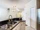 Bright kitchen with granite counters, stainless sink, and views of the staircase at 1810 Shadow View Cir # 1810, Maitland, FL 32751
