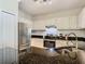 Well-equipped kitchen with stainless steel appliances, granite counters and white cabinetry at 1810 Shadow View Cir # 1810, Maitland, FL 32751