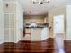 Living room with hardwood floors, views of the kitchen and a side entry door at 1810 Shadow View Cir # 1810, Maitland, FL 32751
