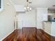 Open living room featuring hardwood floors, staircase, and views of the kitchen at 1810 Shadow View Cir # 1810, Maitland, FL 32751