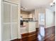 Open-concept living space featuring hardwood floors and a kitchen area at 1810 Shadow View Cir # 1810, Maitland, FL 32751