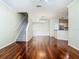Sun-filled living space with hardwood floors, staircase, and open view to the kitchen with stainless appliances at 1810 Shadow View Cir # 1810, Maitland, FL 32751