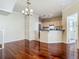 Bright living room with hardwood floors, staircase, and access to the kitchen area at 1810 Shadow View Cir # 1810, Maitland, FL 32751