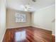 Spacious living room boasts beautiful hardwood floors and a large window, filling the space with light at 1810 Shadow View Cir # 1810, Maitland, FL 32751