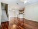 Expansive living room features hardwood floors, staircase, and easy access to the modern kitchen at 1810 Shadow View Cir # 1810, Maitland, FL 32751