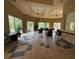Bright meeting room featuring neutral decor, ceiling fans, tile flooring, and large windows with beautiful outdoor views at 1810 Shadow View Cir # 1810, Maitland, FL 32751