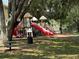 Community playground offers a safe and fun recreational space with slides, swings, and a picnic table at 1810 Shadow View Cir # 1810, Maitland, FL 32751