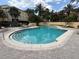 Community pool with lounge chairs and sunbathing area, with steps into the water and depth markings at 1810 Shadow View Cir # 1810, Maitland, FL 32751