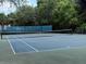 Well-maintained tennis court for recreational enjoyment, surrounded by lush trees for privacy at 1810 Shadow View Cir # 1810, Maitland, FL 32751