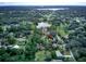 Aerial view of a home surrounded by trees and a lake, offering a serene and private environment at 205 Elaine Pl, Chuluota, FL 32766