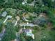 Spacious wooded property with multiple outbuildings and lush greenery surrounding the main house at 205 Elaine Pl, Chuluota, FL 32766