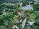 Expansive property featuring a private lake, lush greenery, and a cozy home nestled among the trees at 205 Elaine Pl, Chuluota, FL 32766