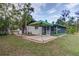 Backyard view featuring a screened-in patio area and a tent, great for outdoor activities and relaxing at 205 Elaine Pl, Chuluota, FL 32766