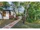 Lush backyard features a brick-lined walkway leading to a tent, set in a private, natural setting at 205 Elaine Pl, Chuluota, FL 32766