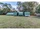 Large backyard with multiple storage containers and ample green space at 205 Elaine Pl, Chuluota, FL 32766