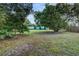 Expansive backyard with lush green lawn and mature trees providing shade and privacy at 205 Elaine Pl, Chuluota, FL 32766