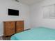 Bedroom features wood-look flooring, natural light, and classic wood dresser at 205 Elaine Pl, Chuluota, FL 32766