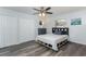 Bedroom featuring hardwood floors, white walls, and double door closet at 205 Elaine Pl, Chuluota, FL 32766