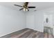 Bedroom features stylish wood-look flooring, closet, and window at 205 Elaine Pl, Chuluota, FL 32766