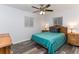 Bedroom features stylish wood-look flooring, ceiling fan, and natural light from the windows at 205 Elaine Pl, Chuluota, FL 32766